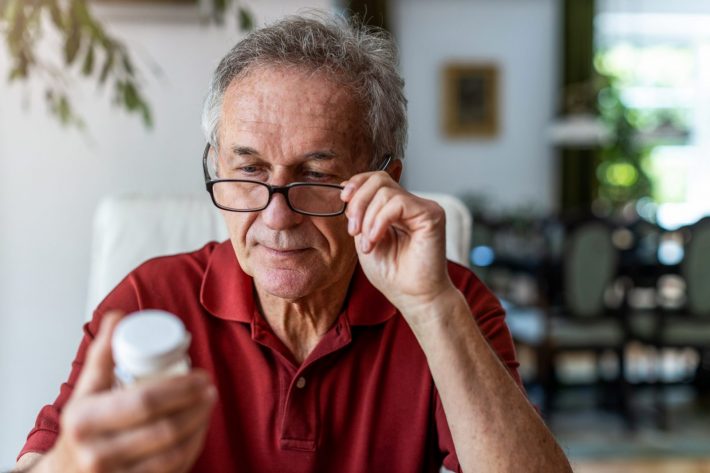 Senior man taking medication covered by his Medicare Part D plan.