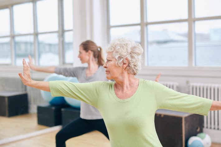 woman participating in a silversneakers class to earn tuition assistance for her loved ones using the silversneakers tuition benefit program