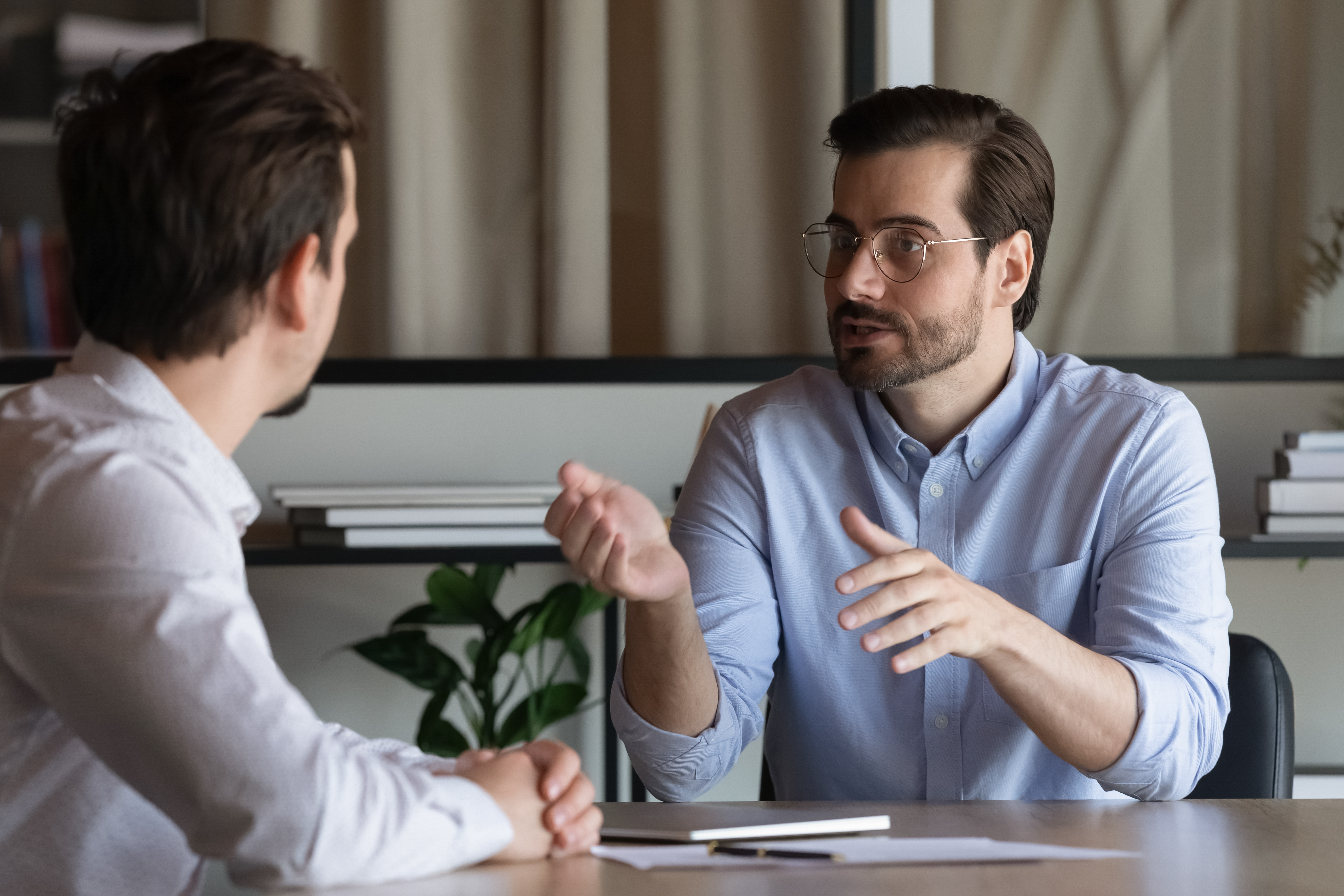 Confident Manager In Glasses Consulting Client At Meeting In Off