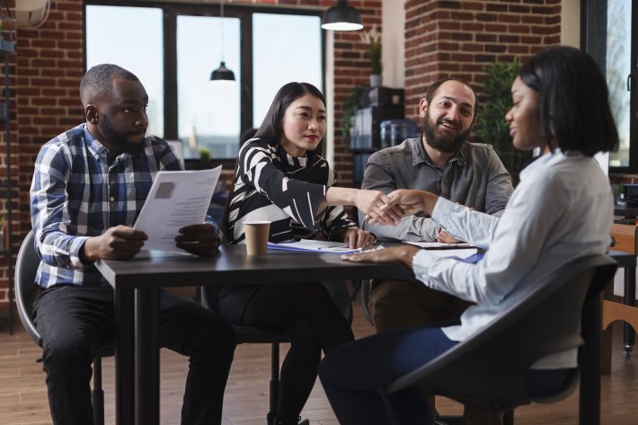 Diverse Financial Company Employers Sitting At Desk While Asian